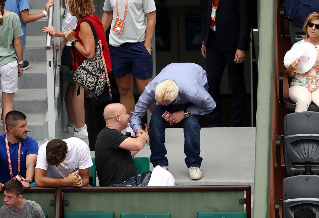 Andre Agassi (left), new coach of Novak Djokovic, speaks with Boris Becker on day two at Roland Garros