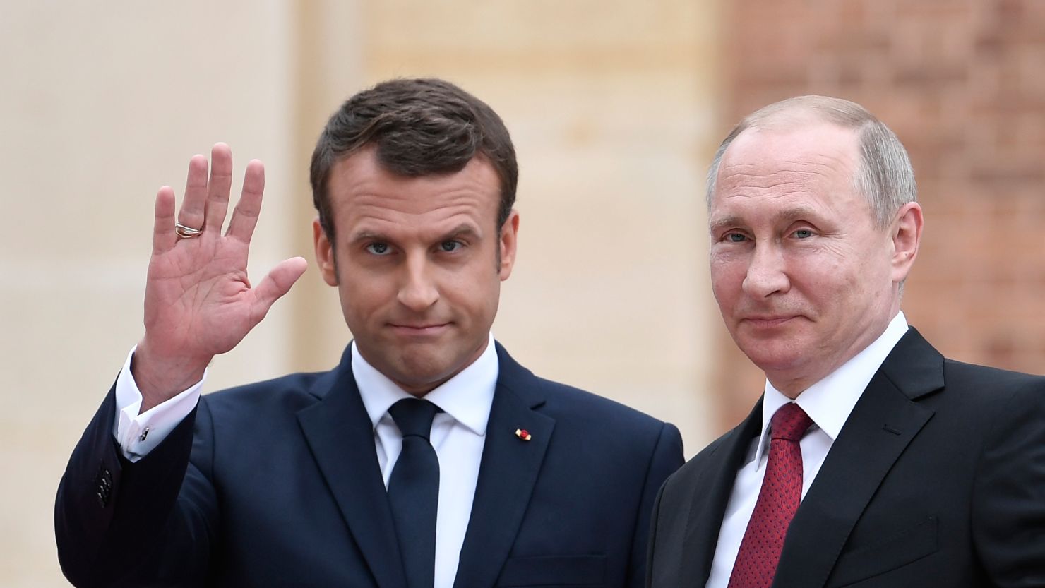 French President Emmanuel Macron welcomes Russian President Vladimir Putin at the Versailles, near Paris, on Monday.
