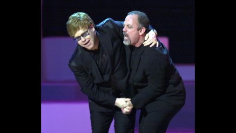 John and Billy Joel dance during the final song of a Brian Wilson tribute in New York in 2001. Wilson was one of the original Beach Boys.