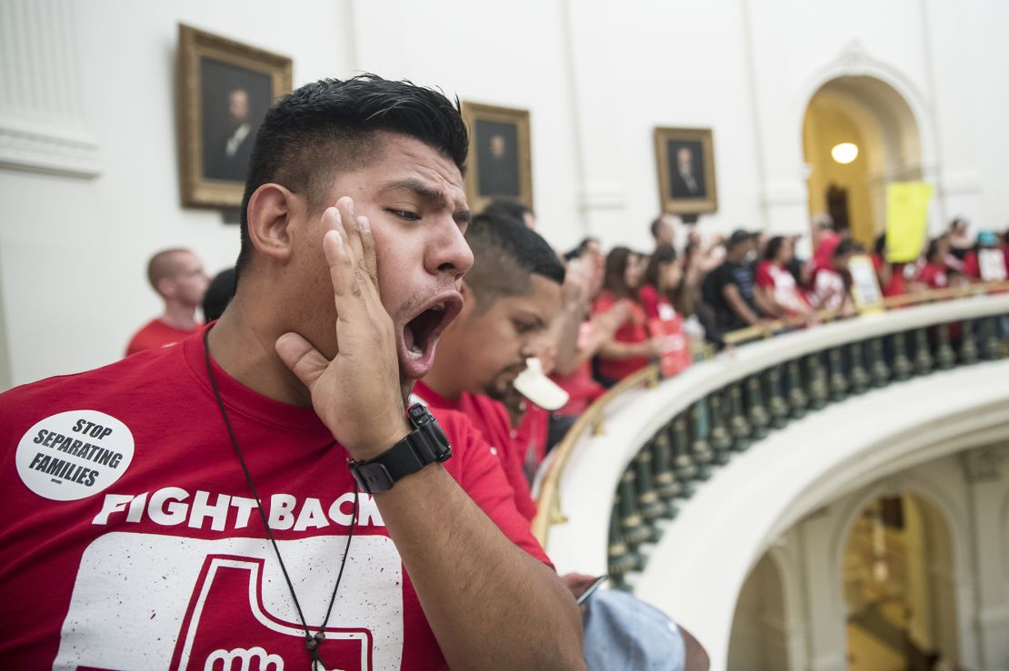 Pedro Paredes joins hundreds of protesters lining the balconies of the state Capitol rotunda in Austin on Monday.