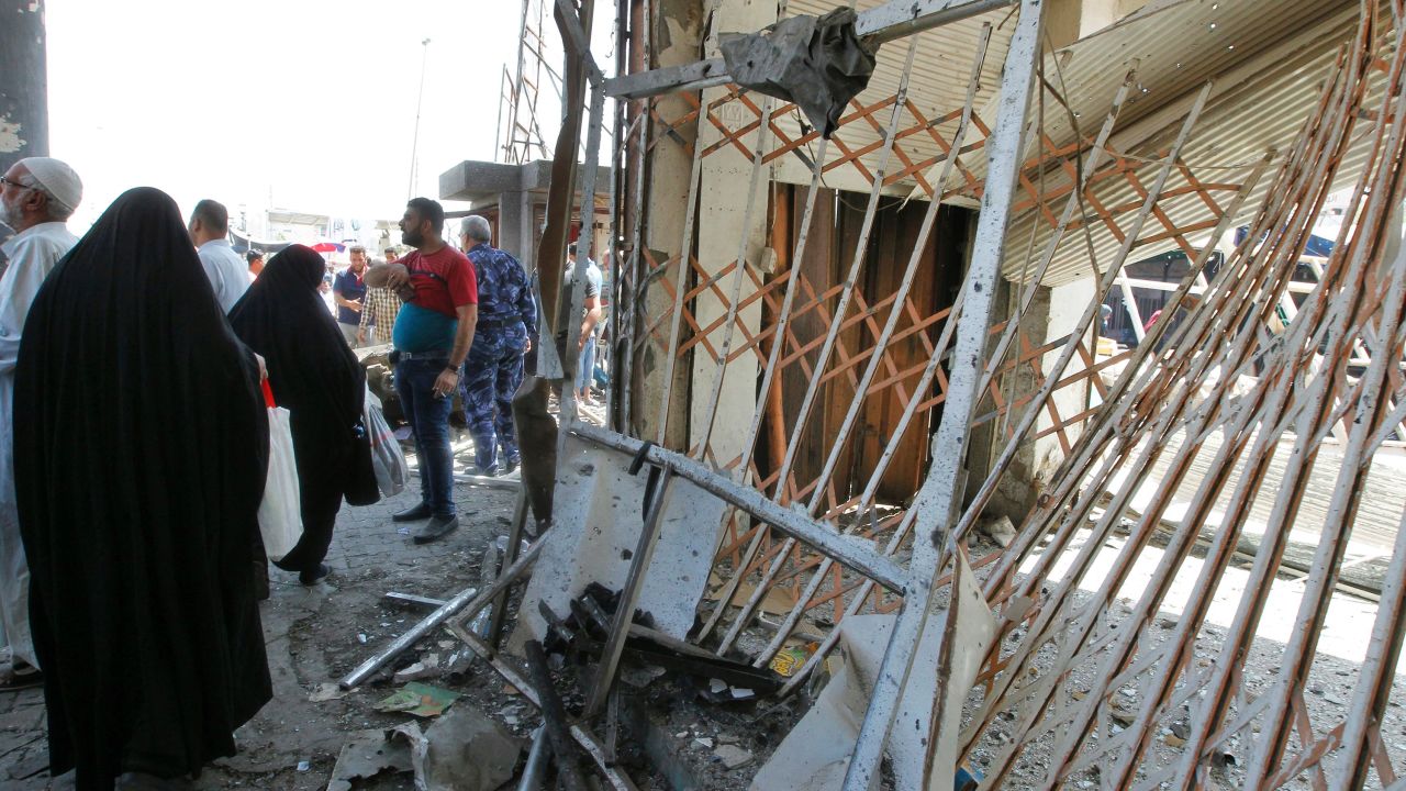 Iraqis gather at the site of a car bomb explosion near Baghdad's General Retirement Department. 
