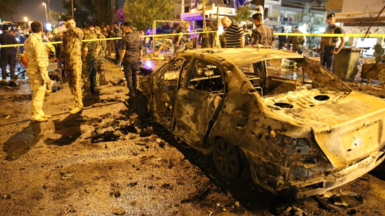 People gather around the blast site early Tuesday.