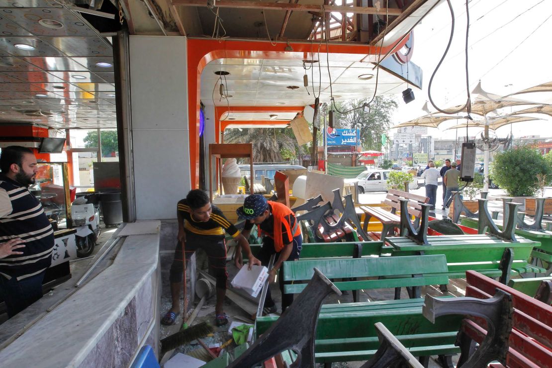 Iraqis check an ice cream shop in Baghdad's Karrada district on May 31, in the aftermath of a car bomb explosion.