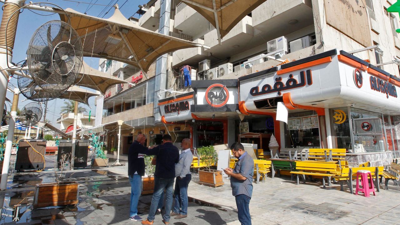 Iraqis inspect an ice cream shop in Baghdad following a bombing there overnight. 