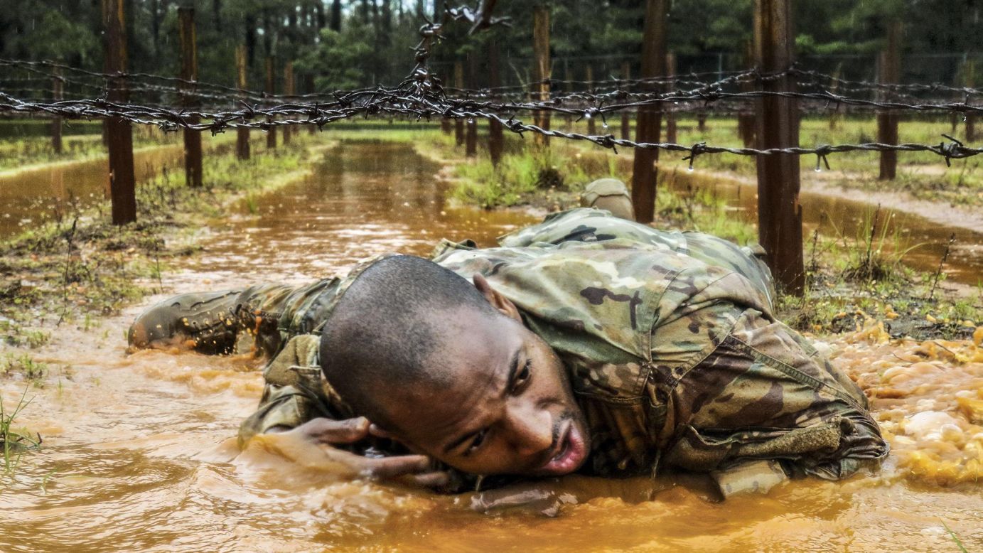 A paratrooper crawls under barbed wire during a "best squad" competition in Fort Bragg, North Carolina, on Tuesday, May 23. It was part of All-American Week, which celebrated the Army's 82nd Airborne Division.