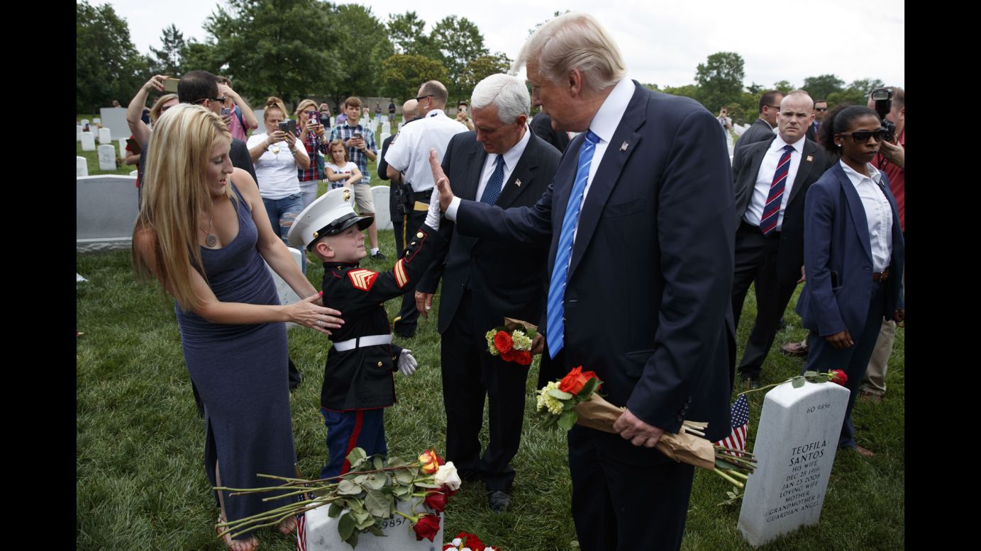Christian Jacobs, 6, high-fives President Donald Trump near his mother, Brittany, and Vice President Mike Pence as they visited Arlington National Cemetery on Memorial Day. Christian's father, Marine Sgt. Christopher Jacobs, was killed in 2011.