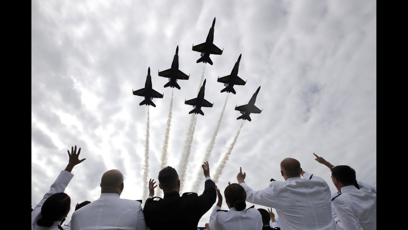 Midshipmen watch the Blue Angels flight team during the graduation ceremony at the US Naval Academy on Friday, May 26.
