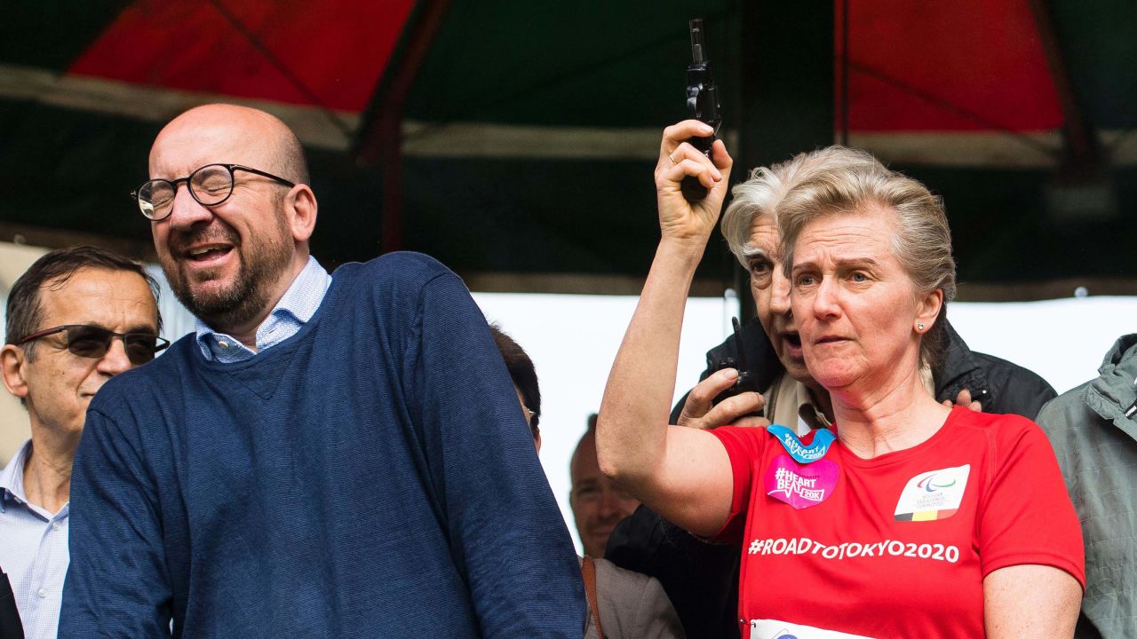 Belgian Prime Minister Charles Michel reacts as Princess Astrid of Belgium fires a starter's pistol signaling the start of a 20K road race Sunday in Brussels. 