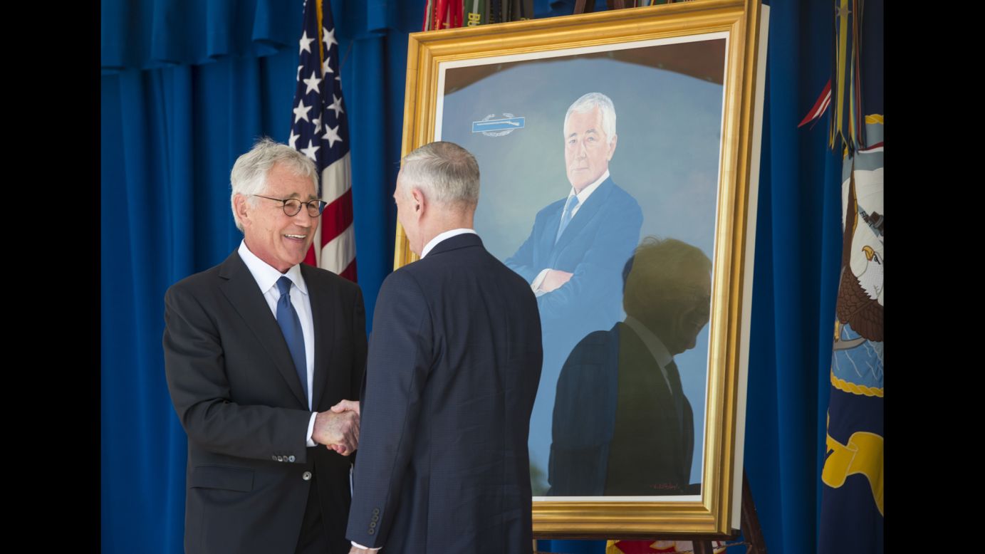 Former Defense Secretary Chuck Hagel, left, shakes hands with current Defense Secretary Jim Mattis as Hagel's official portrait was unveiled at the Pentagon on Friday, May 19. Hagel served from 2013-2015.