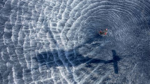 Navy Petty Officer 1st Class Brian Kaltenbach and Petty Officer 2nd Class Aaron Brush prepare a rescue basket before Kaltenbach is hoisted to an MH-60S Seahawk during helicopter search-and-rescue training in waters south of Japan on May 23.