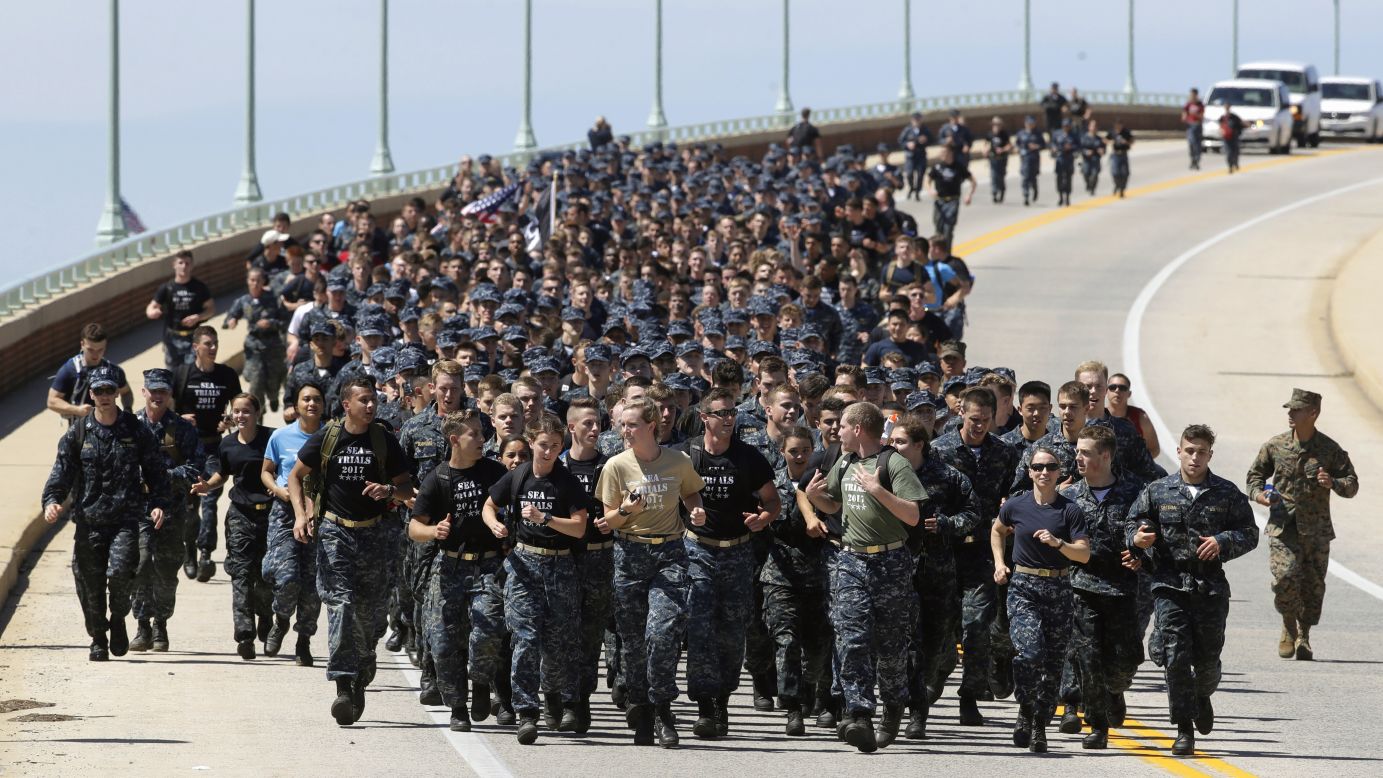 First-year midshipmen, known as "plebes," run across a bridge Tuesday, May 16, during Sea Trials, a daylong training exercise that caps off their year at the US Naval Academy.