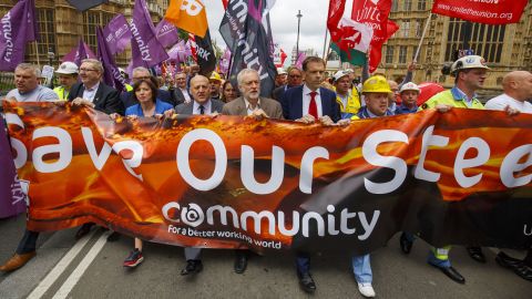 Corbyn (center) marches with demonstrating steelworkers in London in 2016.