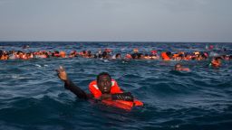 Refugees and migrants are seen swimming and yelling for assistance from a Migrant Offshore Aid Station vessel after a wooden boat bound for Italy carrying more than 500 people capsized last month. 