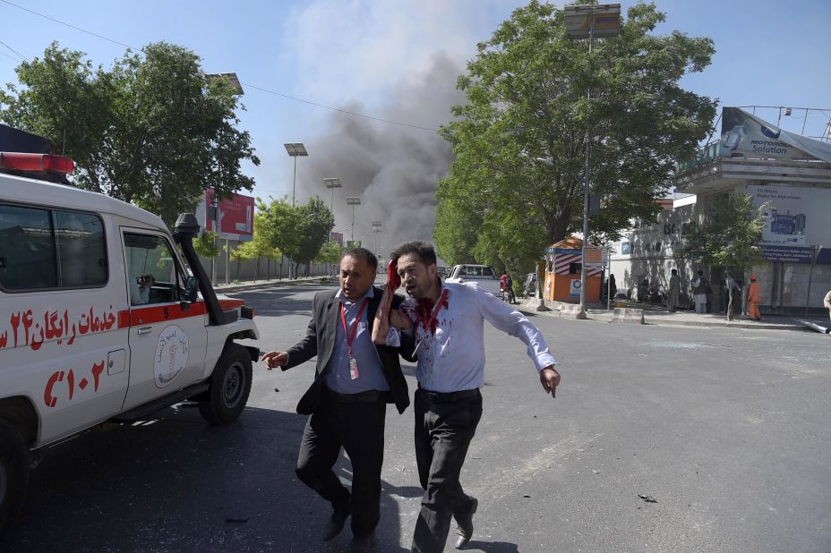 A wounded man is helped away from the scene of the attack, which struck in the midst of Kabul's morning rush hour. 