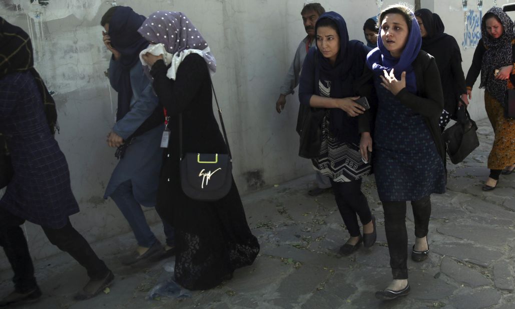 Office workers leave the site of the suicide attack. German Foreign Minister Sigmar Gabriel said the attack was "aimed at civilians and those who are in Afghanistan to work with the people there for a better future of the country."