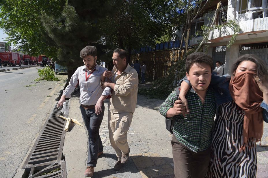 Bystanders help evacuate people from the area of the explosion. 