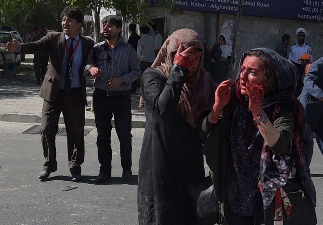 Women covered in blood stand dazed in the aftermath of the attack near Kabul's highly secure diplomatic area.