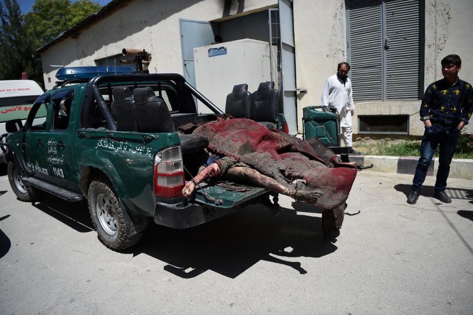 Victims' bodies are placed in the back of a police truck at a hospital in Kabul.