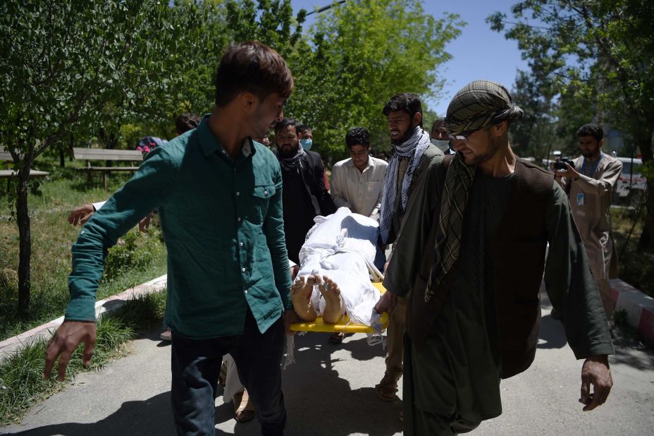 Volunteers carry the body of a victim to the Wazir Akbar Khan Hospital in Kabul.