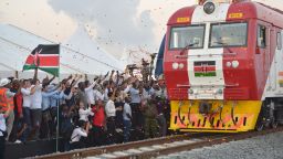 People cheer and throw confetti, after Kenyan President Uhuru Kenyatta flags off a cargo train for its inaugural journey to Nairobi, at the port of the coastal town of Mombasa on May 30, 2017.
More than a century after a colonial railway gave birth to modern Kenya, the country is betting on a new Chinese-built route to cement its position as the gateway to East Africa. The $3.2 billion (2.8 billion euro) railway linking Nairobi with the port city of Mombasa will May 31 take its first passengers on the 472 kilometre (293 mile) journey, allowing them to skip a hair-raising drive on one of Kenya's most dangerous highways.  / AFP PHOTO / TONY KARUMBA        (Photo credit should read TONY KARUMBA/AFP/Getty Images)