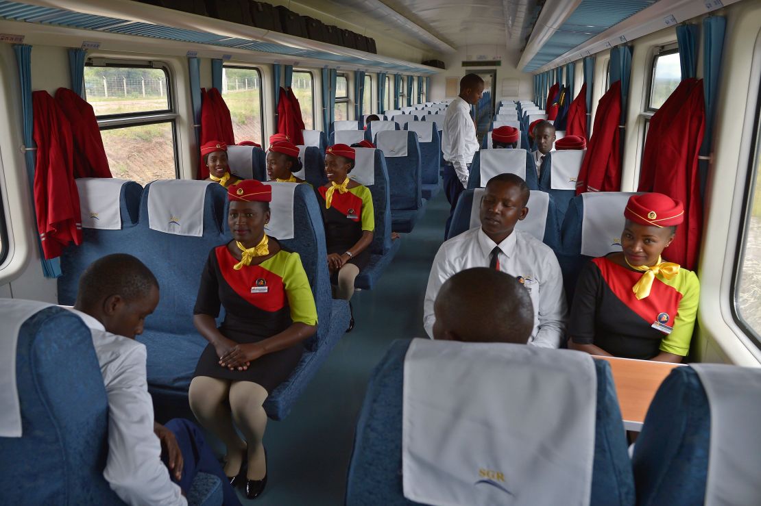 Hospitality crew members inside a new passenger train.