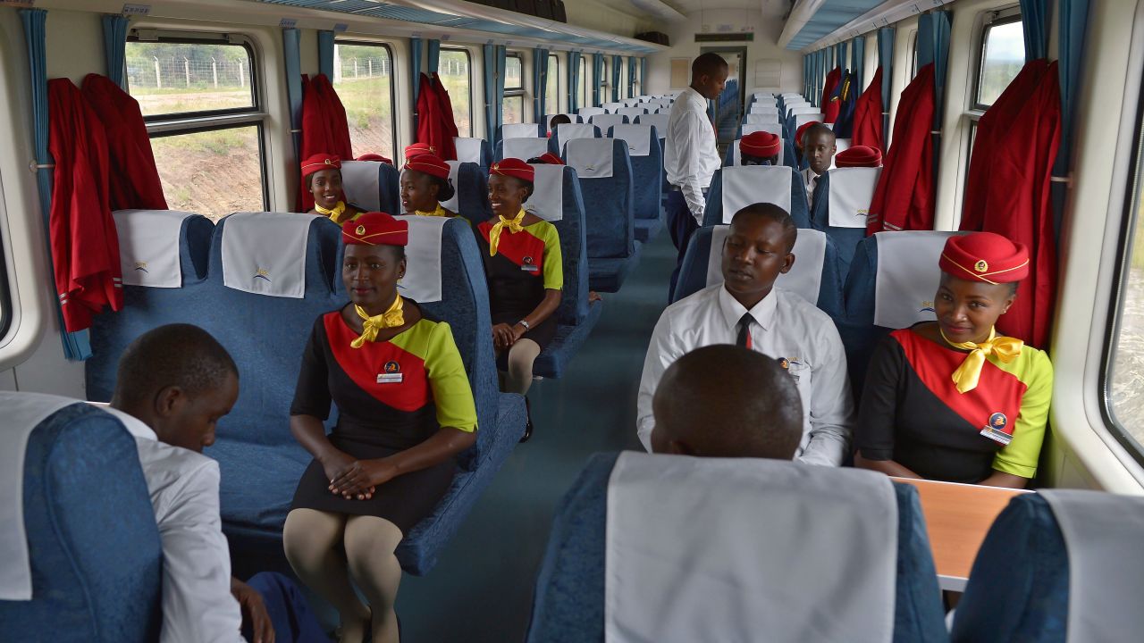 Hospitality crew members inside a new passenger train.