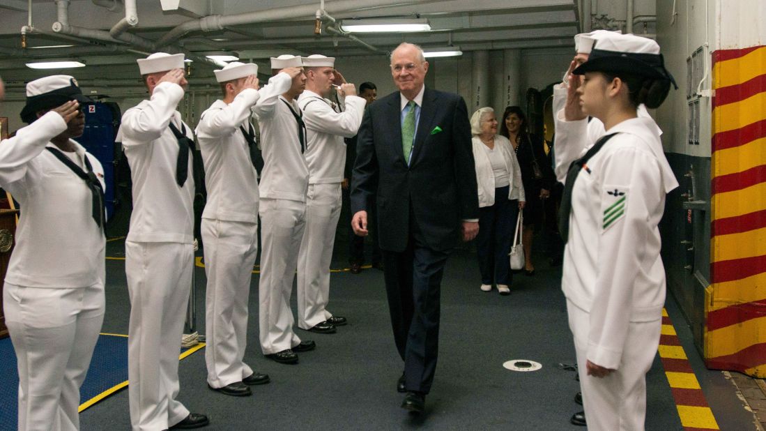 Kennedy is saluted by sailors as he tours the USS John C. Stennis in 2015.
