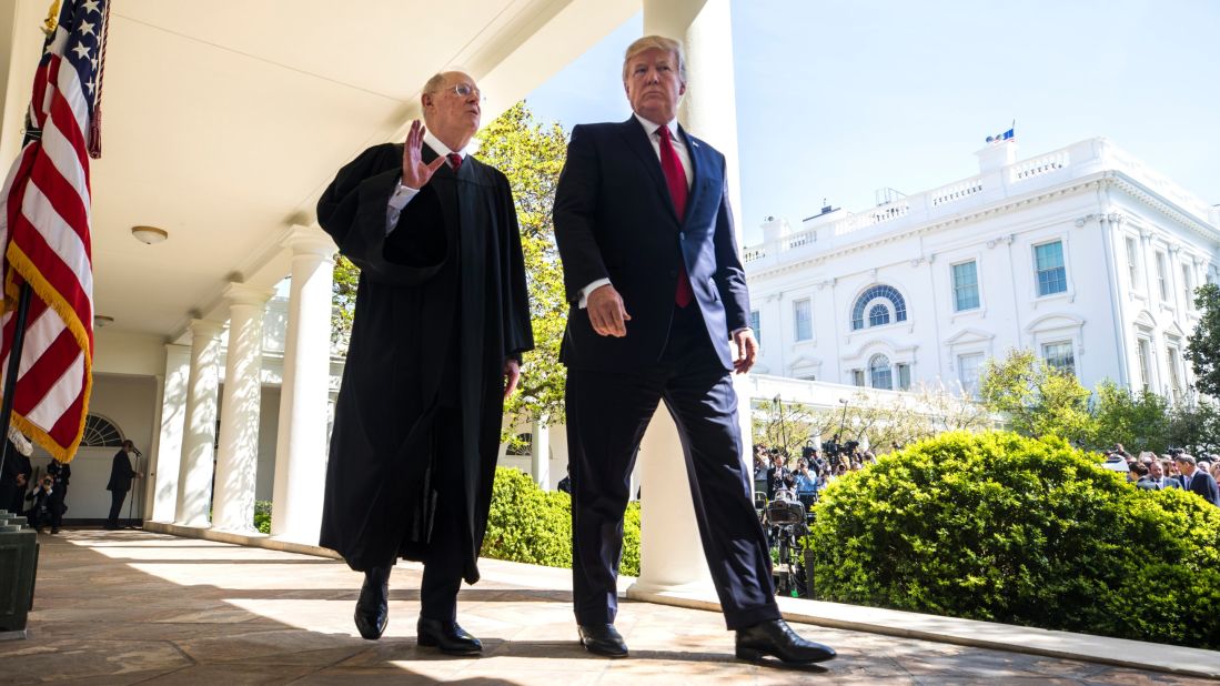 Kennedy and Trump walk together after Gorsuch's swearing-in ceremony.