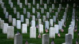 American flags are placed at graves at Arlington National Cemetery on May 25, 2017 in Arlington, Virginia in preparation for Memorial Day. / AFP PHOTO / Brendan SMIALOWSKI        (Photo credit should read BRENDAN SMIALOWSKI/AFP/Getty Images)