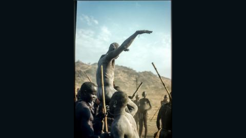 A victorious Nuba wrestler held aloft by his defeated competition. Until now, Rodger's Sudan pictures had only been published in monochrome.