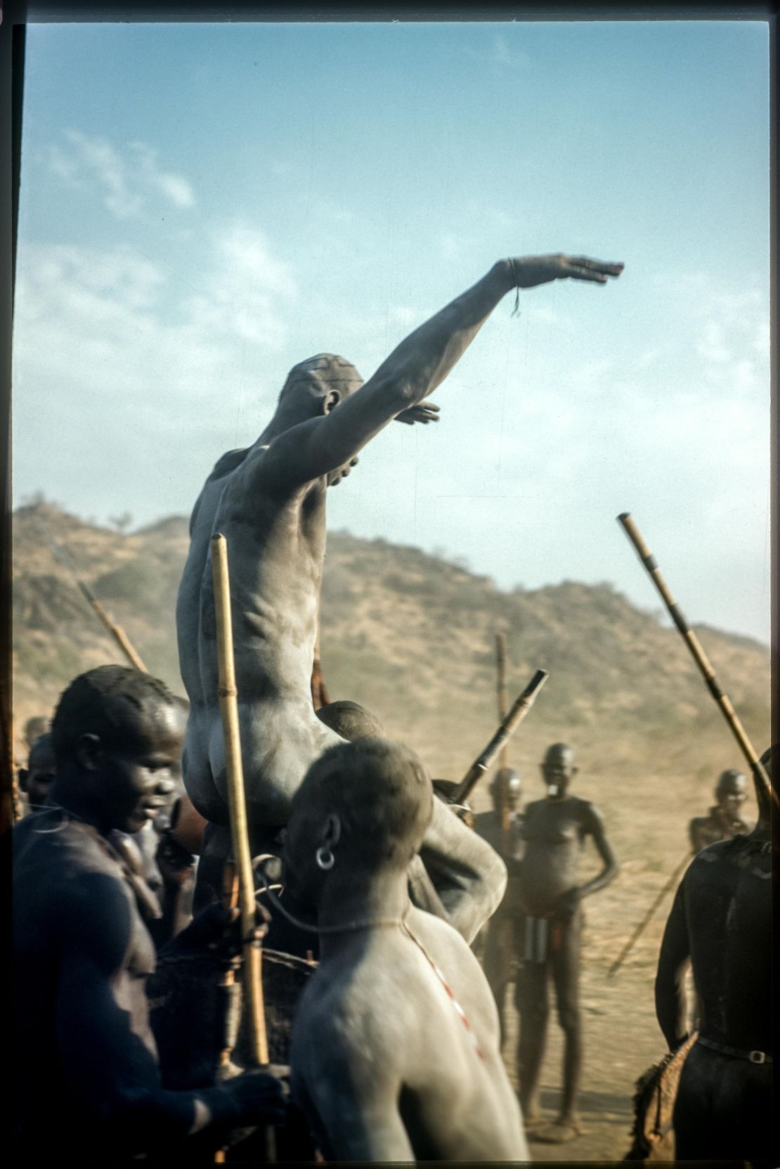 A victorious Nuba wrestler held aloft by his defeated competition. Until now, Rodger's Sudan pictures had only been published in monochrome.