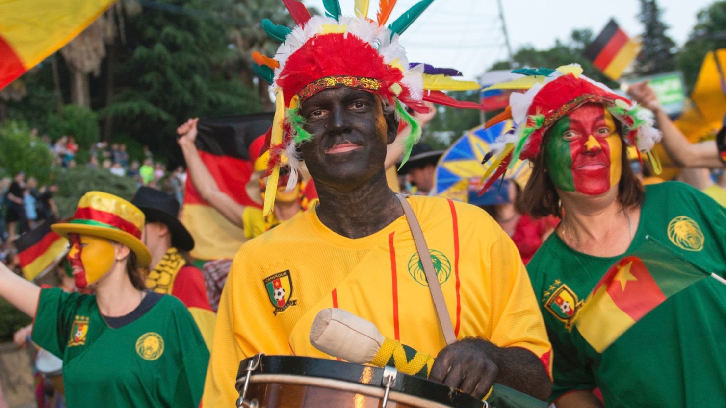 People in blackface and carry bananas while marching in a government-backed parade in Sochi, Russia on May 27. The city will host one of Cameroon's matches at the Confederations Cup soccer tournament  