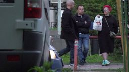 Anna Alimova offers a bag of syringes, bandages and ointments to a man leaving a 24-hour pharmacy.