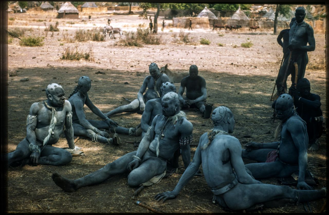 Korongo Nuba wrestlers wait to compete under the shade of a boabab tree, 1949.