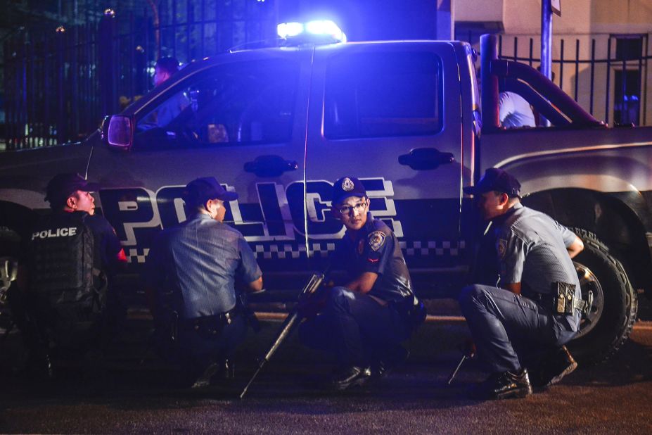 Police take positions outside the resort.