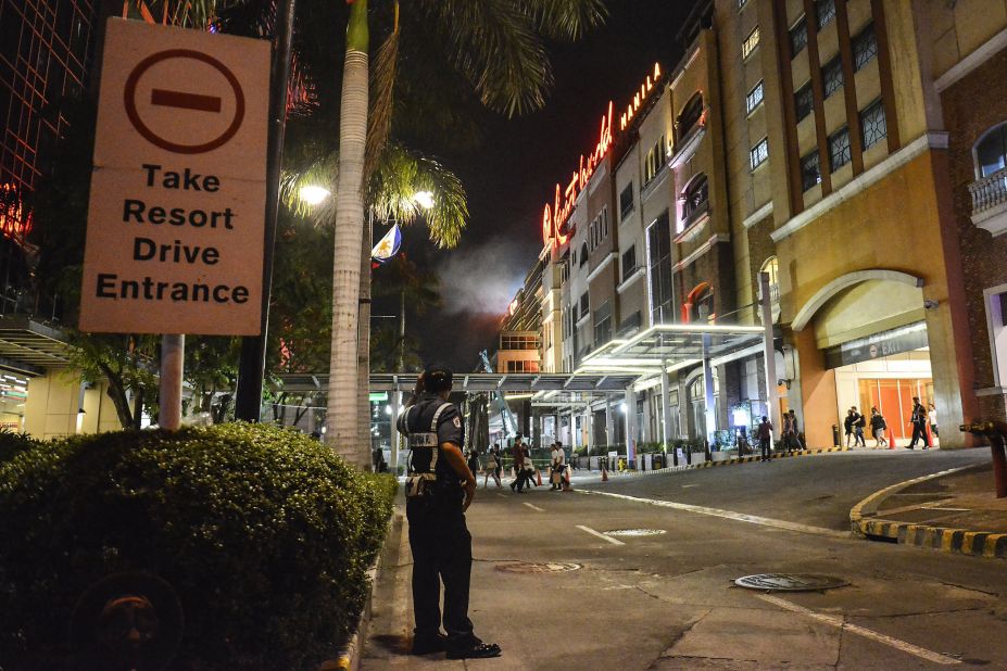 A police officer stands guard outside the resort.