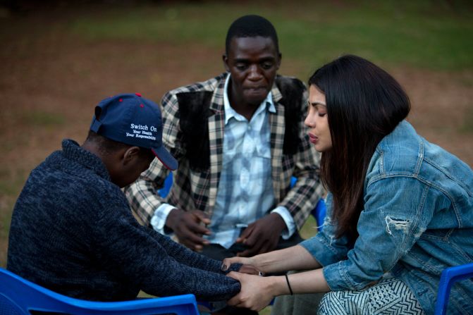 On May 4, 2017 in Zimbabwe, UNICEF Goodwill Ambassador Priyanka Chopra (right), accompanied by a young man, comforts another youth living with HIV, at the AFRICAID support centre in Avondale, a suburb of Harare, the capital. AFRICAID provides specialized services in support of the Government's National Action Plan for Orphans and Vulnerable Children. 