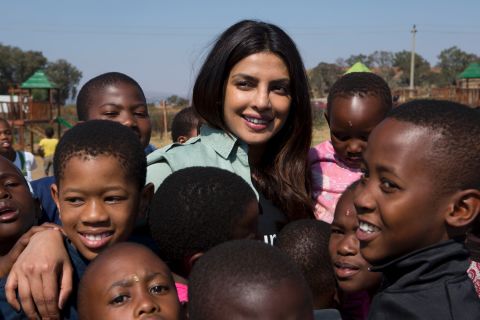 On May 7, 2017 in South Africa, UNICEF Goodwill Ambassador Priyanka Chopra smiles amid a group of children, at the Isibindi Safe Park in Soweto Township, in the city of Johannesburg. 