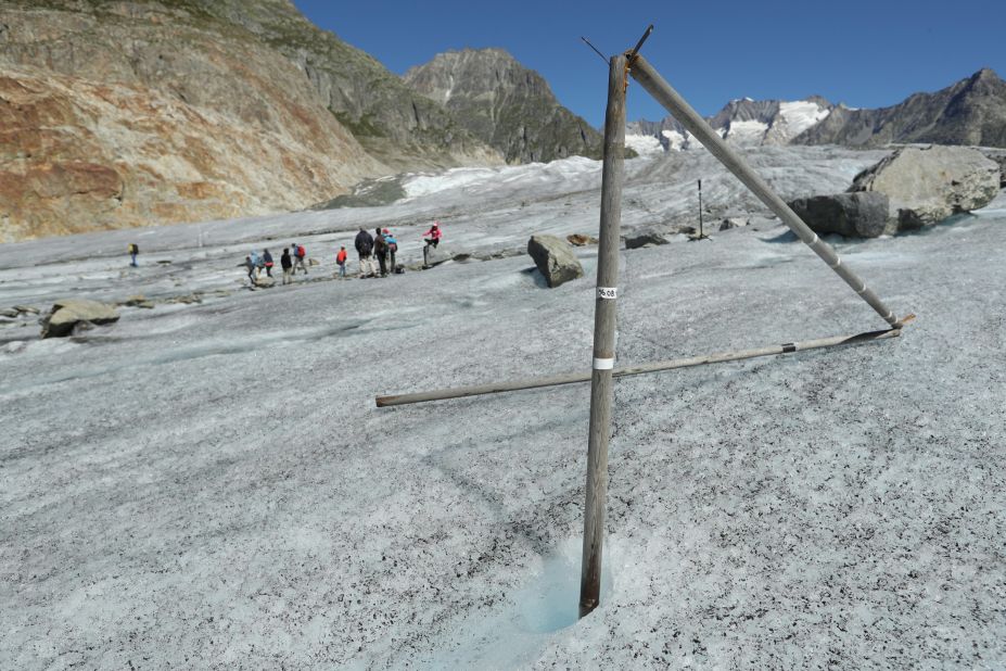 A wooden pole that had been driven into the ice the year before now stands exposed as the Aletsch glacier melts and sinks at a rate of about 10-13 meters per year near Bettmeralp, Switzerland. 