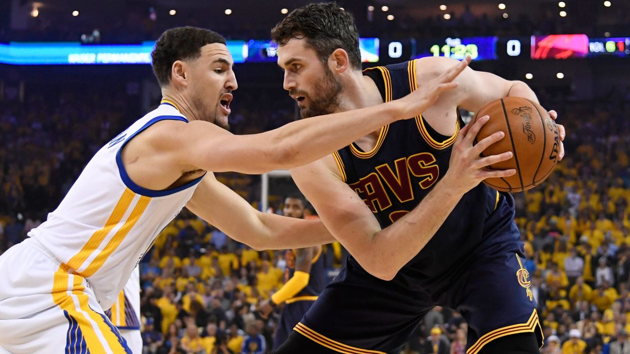 Klay Thompson guards Love in the first quarter of Game 1.