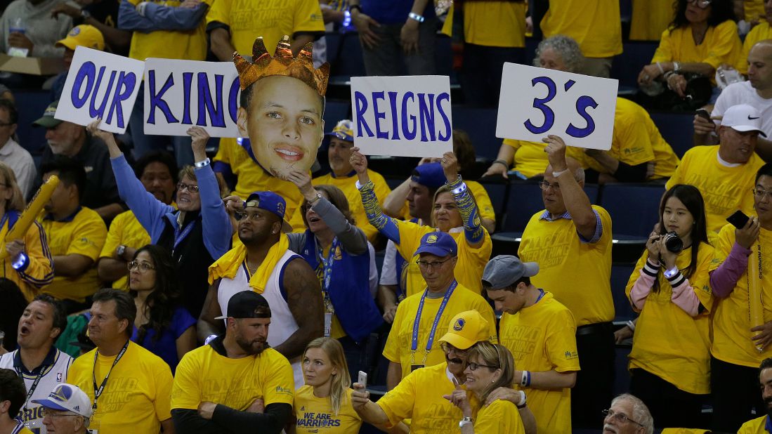 Fans hold up signs for Curry during the second half of Game 1.
