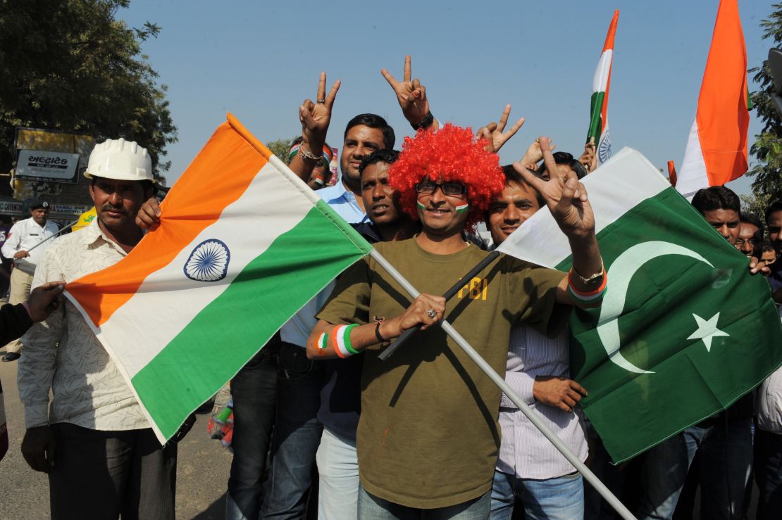 An Indian fan poses with  flags of India and Pakistan outside the Sardar Patel Gujarat Stadium, on December 28, 2012.