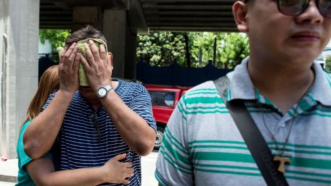 Family members of a victim cry Friday outside the Resorts World Hotel in Manila.