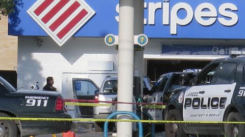 Laredo Police investigators survey the scene of a fatal shootout.