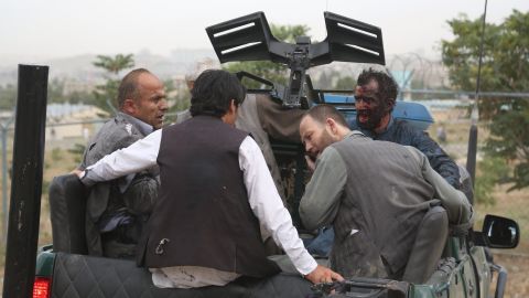 Injured men gather in the back of a pickup truck after the Saturday blasts.