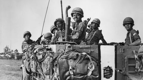 June 1967: Israeli soldiers smile and raise their hands from the bed of a large army truck during the Six Day War at Abu Agillah in the Gaza Strip.