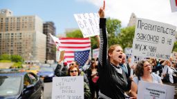 Demonstrators take part in an anti-Trump "March for Truth" rally at Foley Square on June 3, 2017 in New York City. The sign in Russian reads, "Government of Laws, not men" - John Adams.