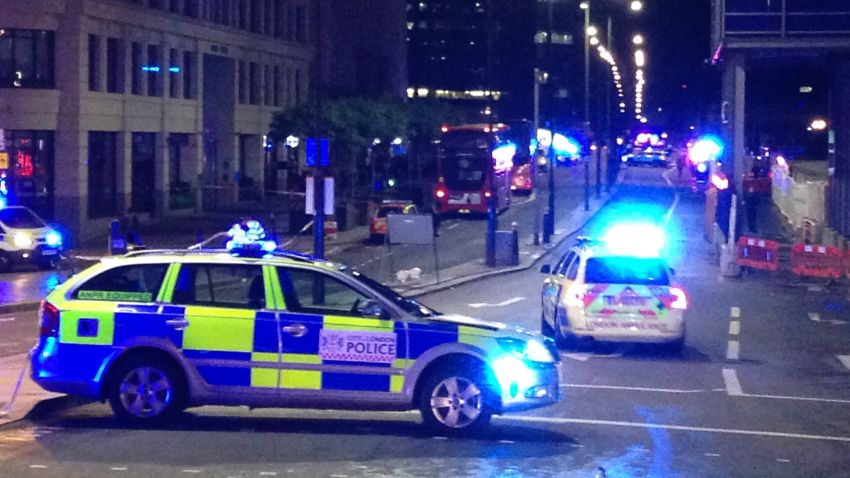 A photograph taken on a mobile phone shows British police cars blocking the entrance to London Bridge, in central London on June 3, 2017, following an incident on the bridge. 
Police are dealing with a "major incident" on London Bridge, Transport for London said on Saturday, after witnesses reported seeing a van mounting the pavement and hitting pedestrians. / AFP PHOTO / Daniel SORABJI        (Photo credit should read DANIEL SORABJI/AFP/Getty Images)