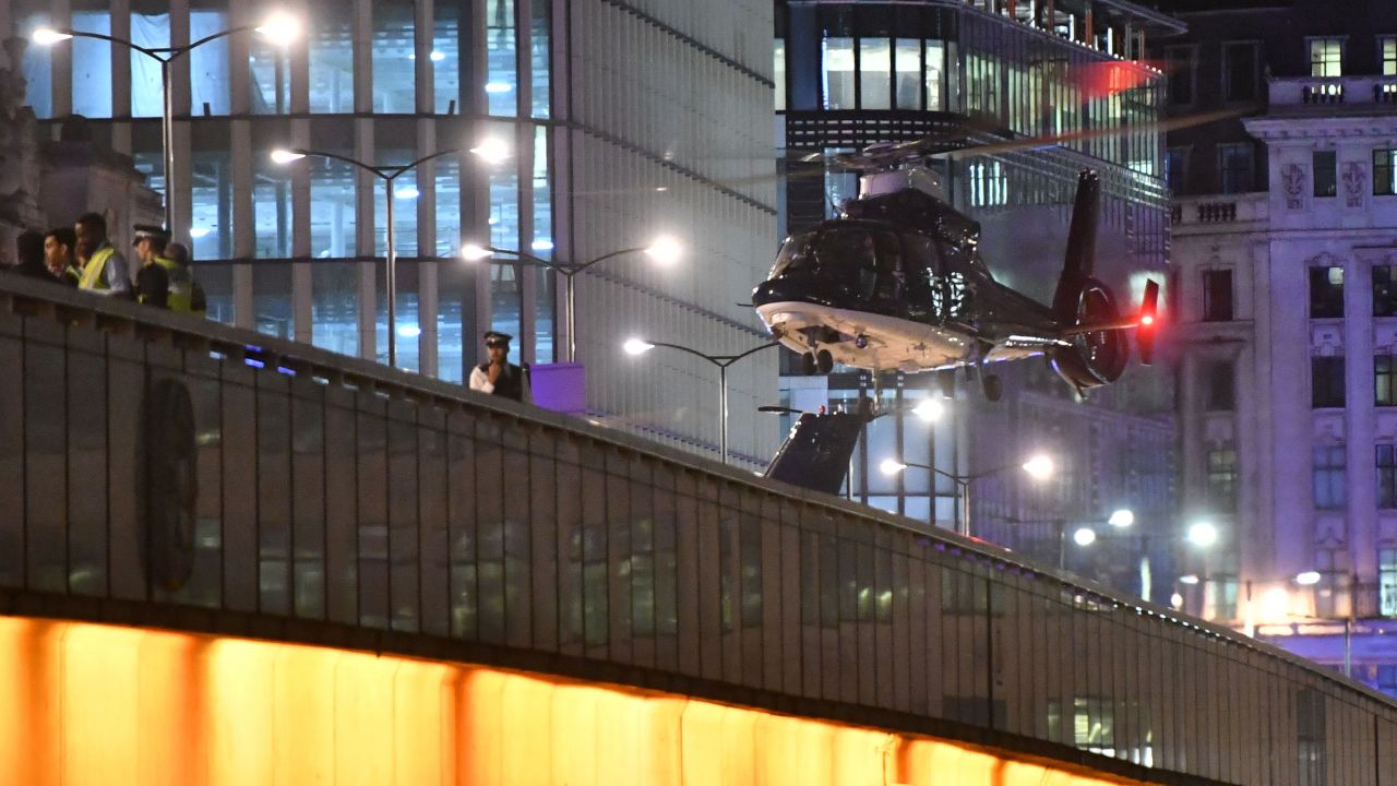 A helicopter flies near London Bridge.