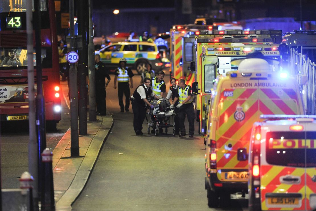 Police officers and members of the emergency services attend to a person injured in the June 3 attack on London Bridge.